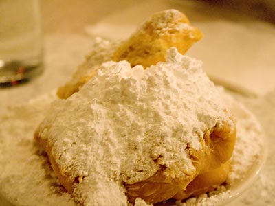 Beignets from Cafe du Monde piled high with powdered sugar.